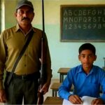 अध्यापक अरुण रावत बंदूक लेकर स्कूल जाते एक छात्र को पढ़ाने।